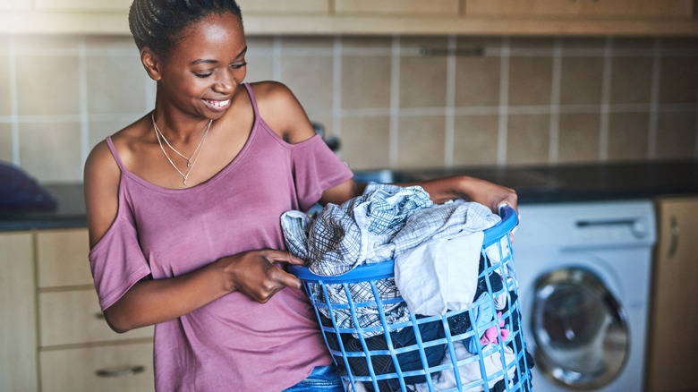 Young woman carrying a laundry basket
