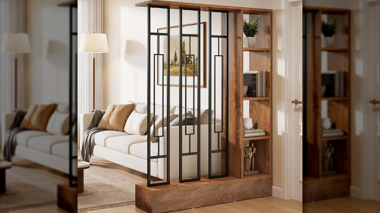 A living room with a '60s-style wooden partition with shelves in front of a white couch