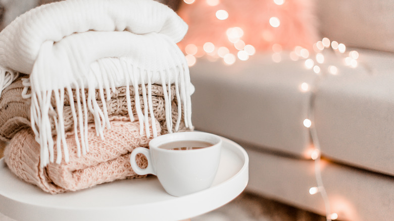 Pile of blankets on a coffee table in a living room