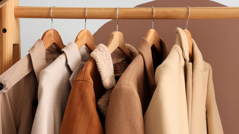 Close-up of a rack with coats and jackets hanging from the rail