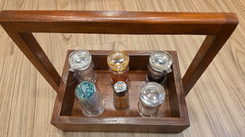 Top-down view of seasonings stored in a wooden caddy