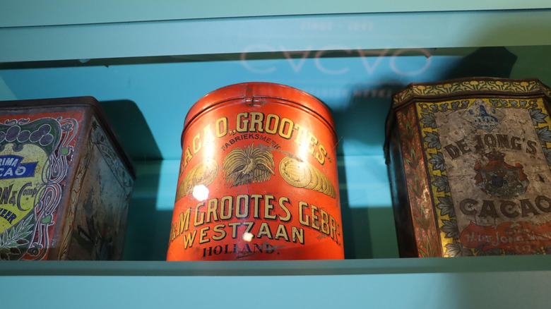 A blue shelf with vintage tins