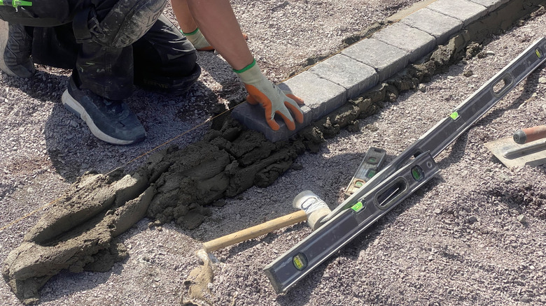 Person installing stone edging