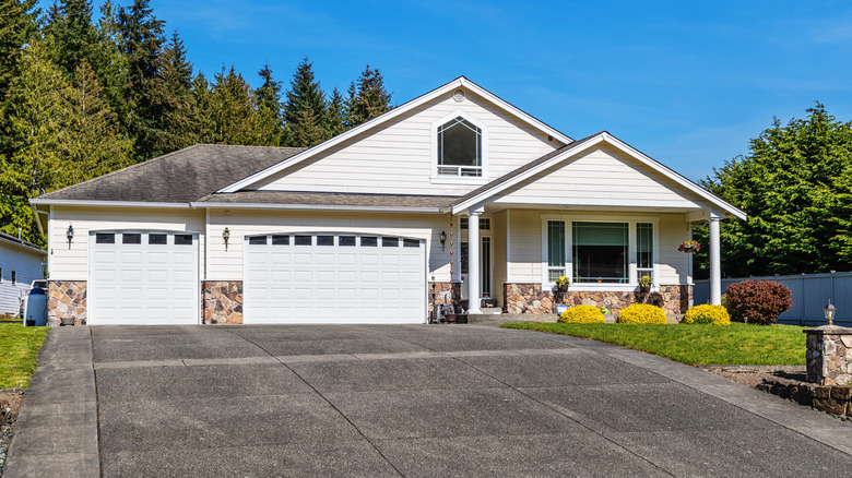 Suburban detached house with a large driveway and front garden