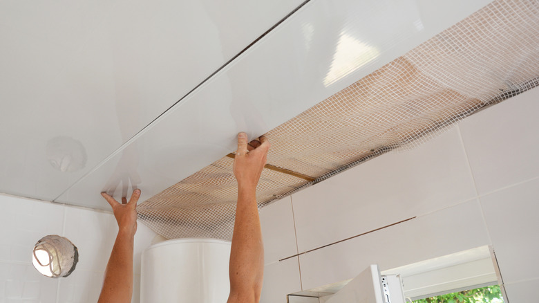 Installing tile panels ceiling