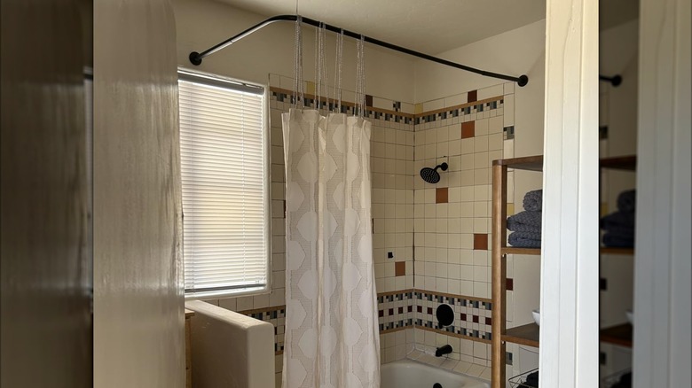 shower curtain on tall rod with extenders in a tiled bathroom