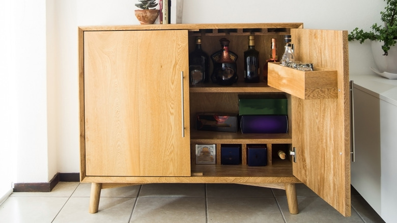 Large wooden bar cabinet with one door open