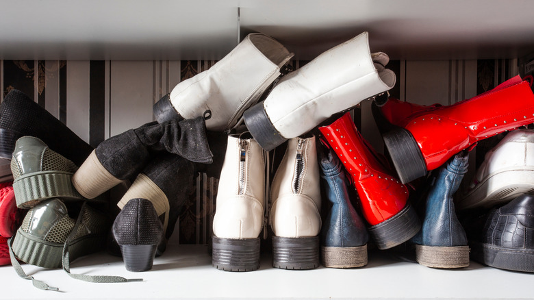 Cluttered shoes piled on top of each other