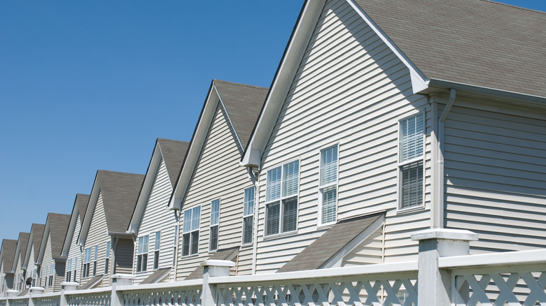 A row of identical homes with the same vinyl siding