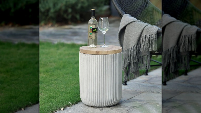 LuxenHome side table on patio with a glass of wine and bottle of wine on top