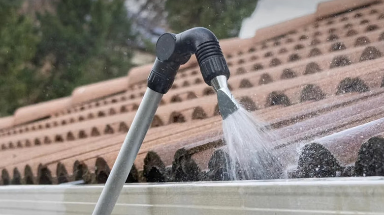 Orbit Telescopic Gutter Cleaning Wand spraying water into gutter