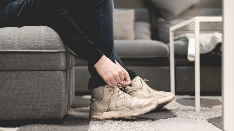 person sitting to put shoes on