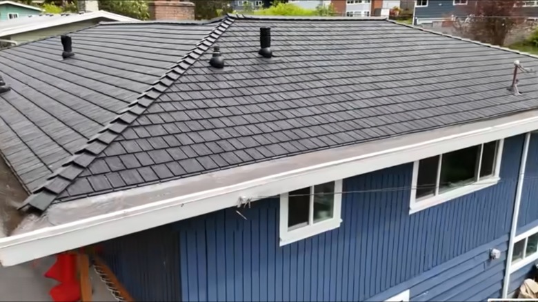 A house roof finished with shingles made of recycled tires.
