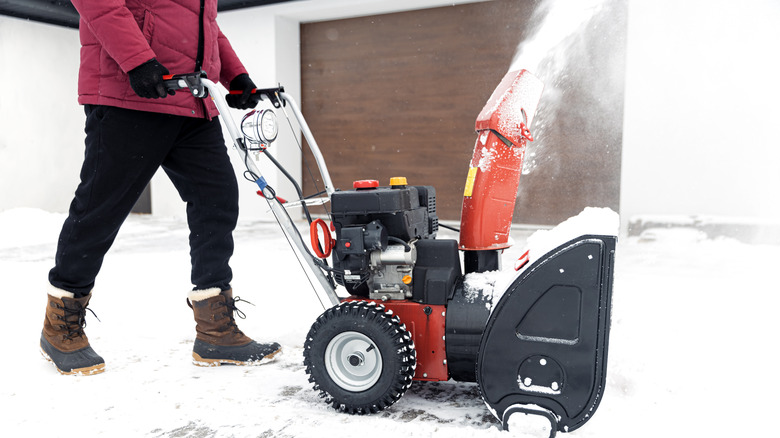 Person using a snow blower