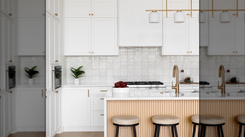 A white kitchen with a square tile backsplash.