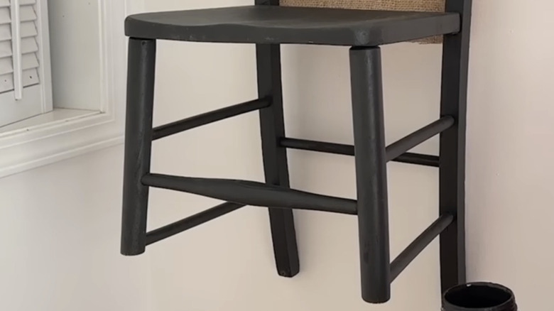Wall shelf constructed from an old chair on wall