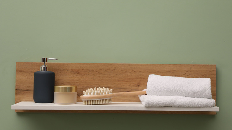 A floating wooden shelf in a bathroom