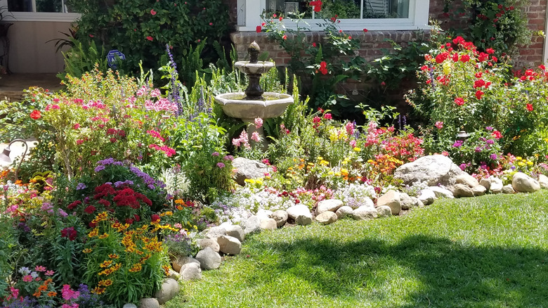 bird bath in a flowering back yard