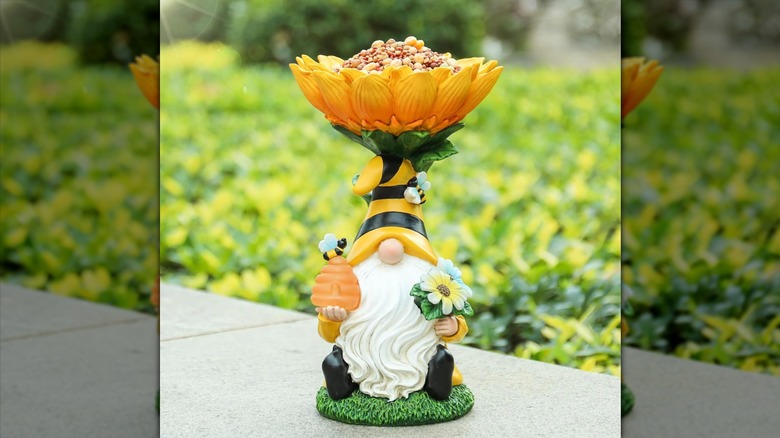 Gnome bird feeder or bird bath on pavement