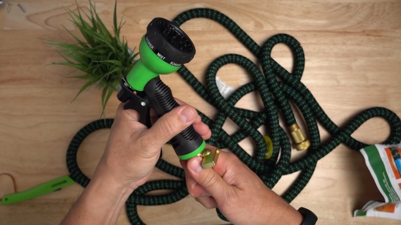 Person screwing spray head to Flexi Hose