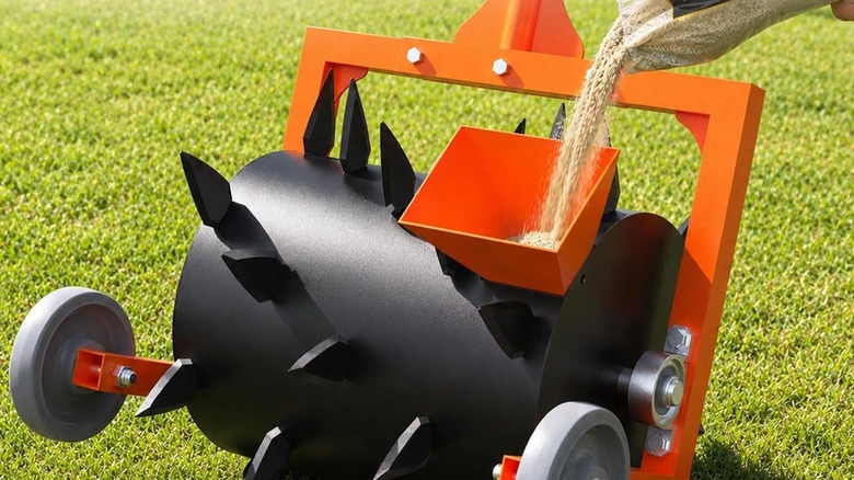Person filling an aerator drum with sand