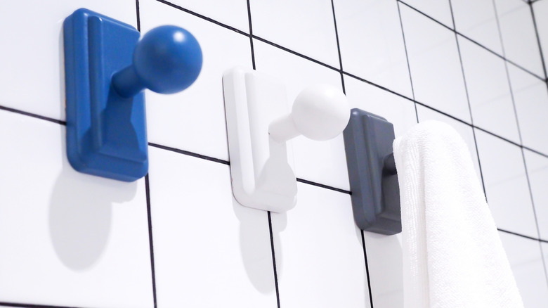 White towel hanger on wooden knobs in bathroom