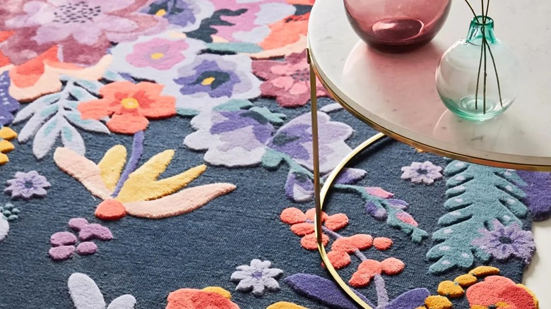 Close up of Amazon's Anthropologie dupe hand-tufted colorful wool floral rug