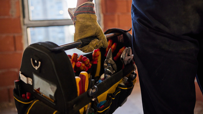 Someone holding a yellow tool box
