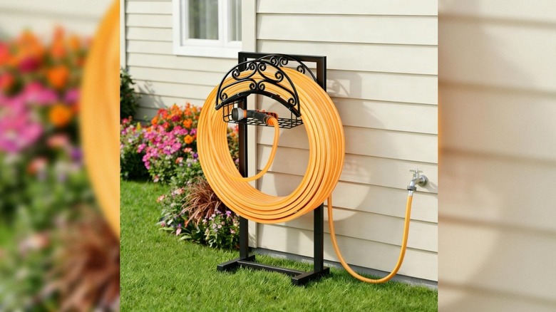yellow hose wrapped around Gayuteay Garden Hose Holder