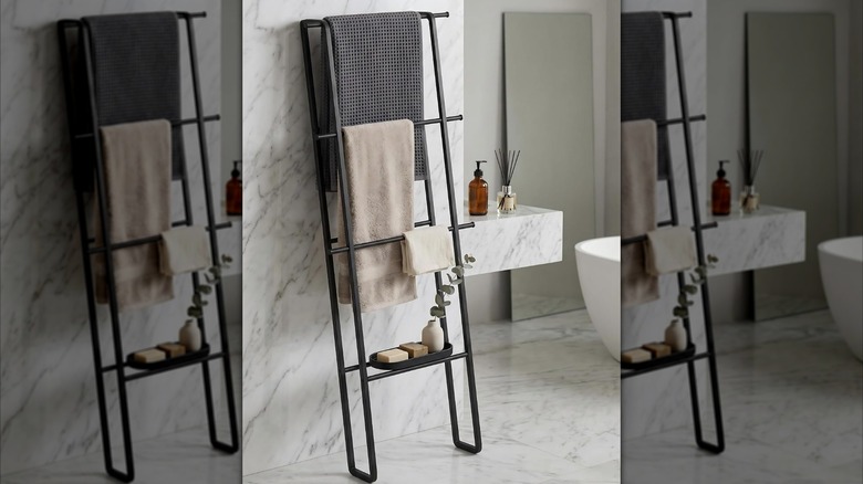 A towel ladder rack with towels and a small soap holder.