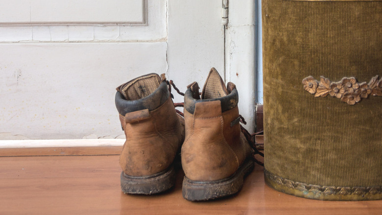 Brown boots on floor in front of door