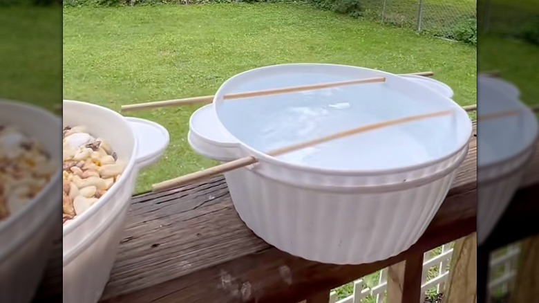 birdbath made from mixing bowls on a porch railing