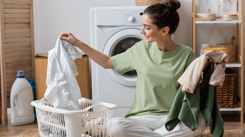 Woman sorting laundry in basket