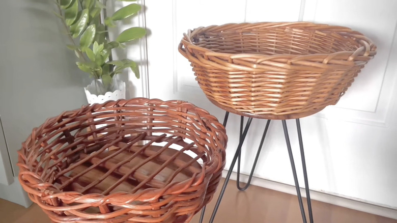 Two wicker basket side tables with metal hairpin legs