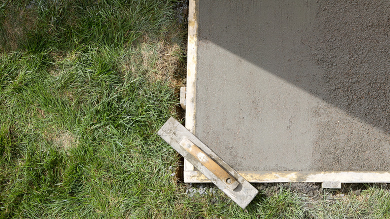 corner of poured concrete over grass