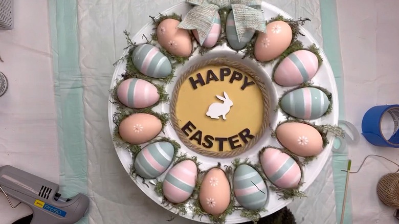 Plastic egg plate wreath on a craft table
