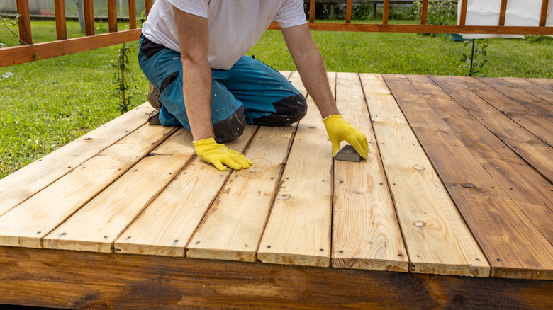 man working on backyard deck