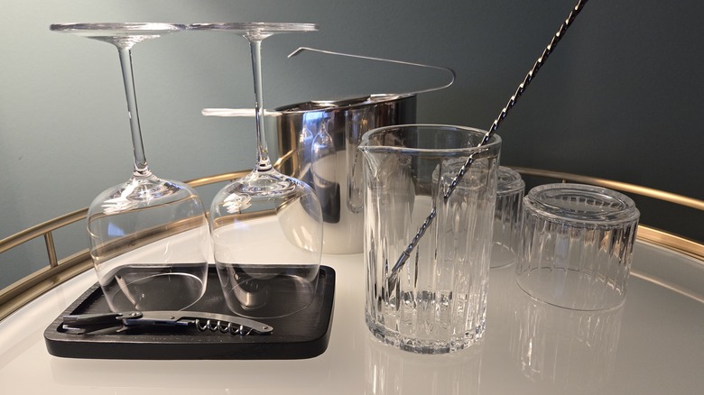 Glassware and bar essentials on a gold-rimmed bar cart