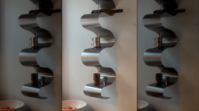 Curvy wall-mounted chrome shelf