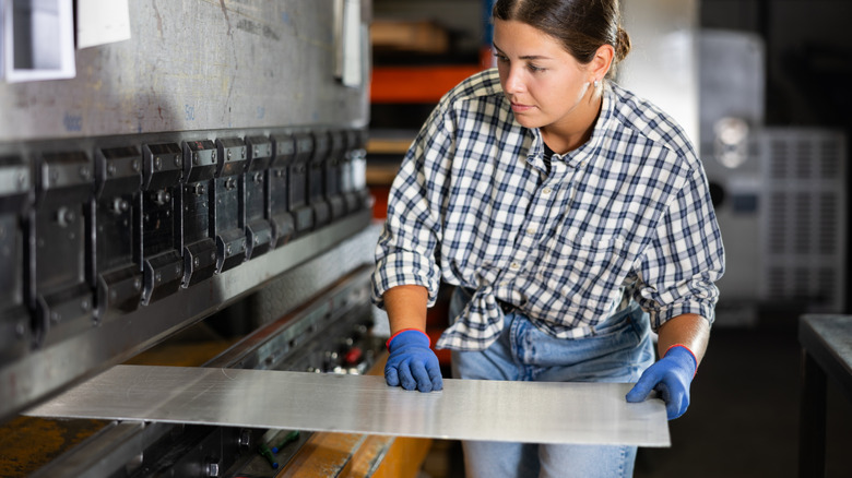 Person working with a sheet of steel