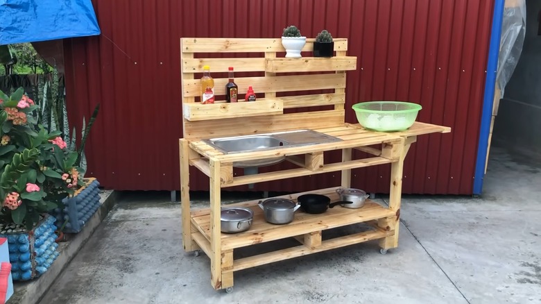 Outdoor mud kitchen's with pots and pans.