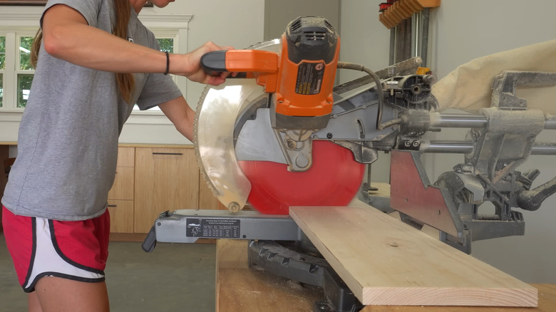 Someone cutting wood boards with a circular saw.