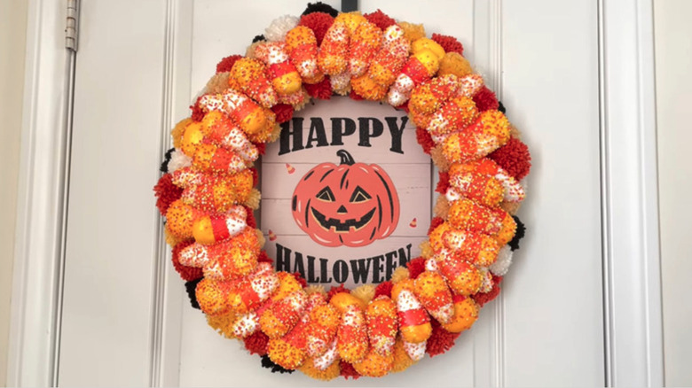DIY candy corn Halloween wreath on a white front door