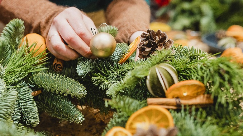 Person working on Christmas decorations