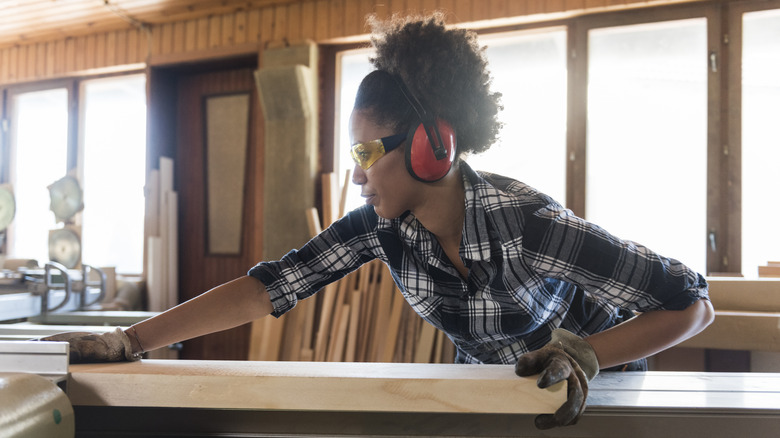 woman cutting wood