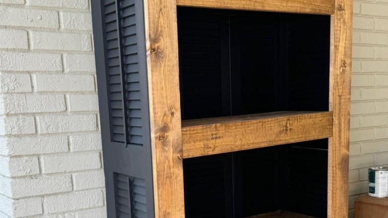 A bookcase made from shutters and wood