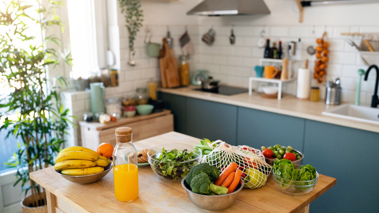 Kitchen with lots of produce on the counters