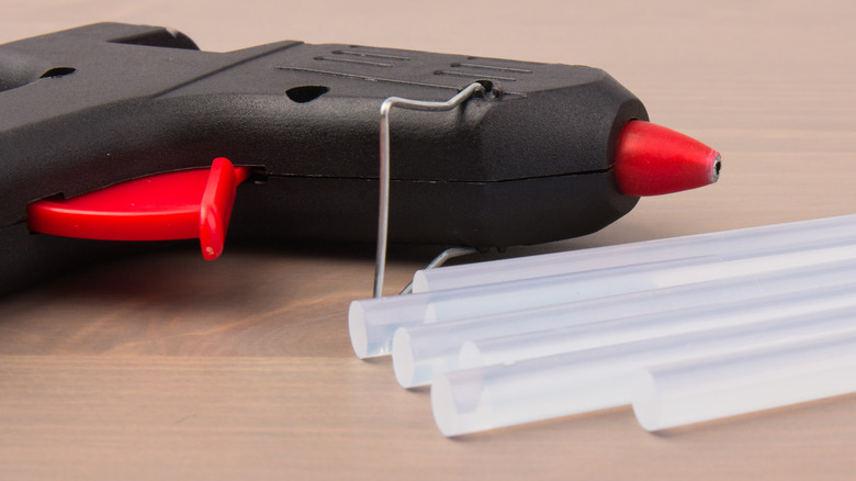 person holding glue gun