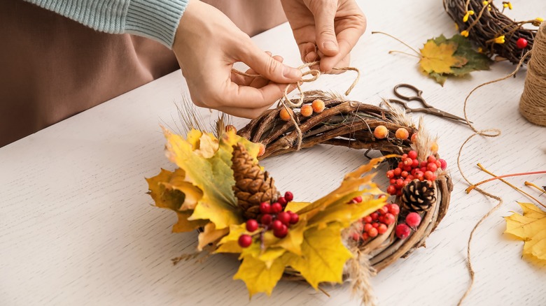 someone making a fall wreath 