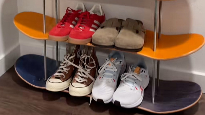 Shoes on a skateboard shoe rack.